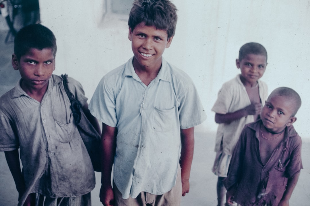 a-group-of-young-boys-standing-next-to-each-other-ll2gvh6ak4s