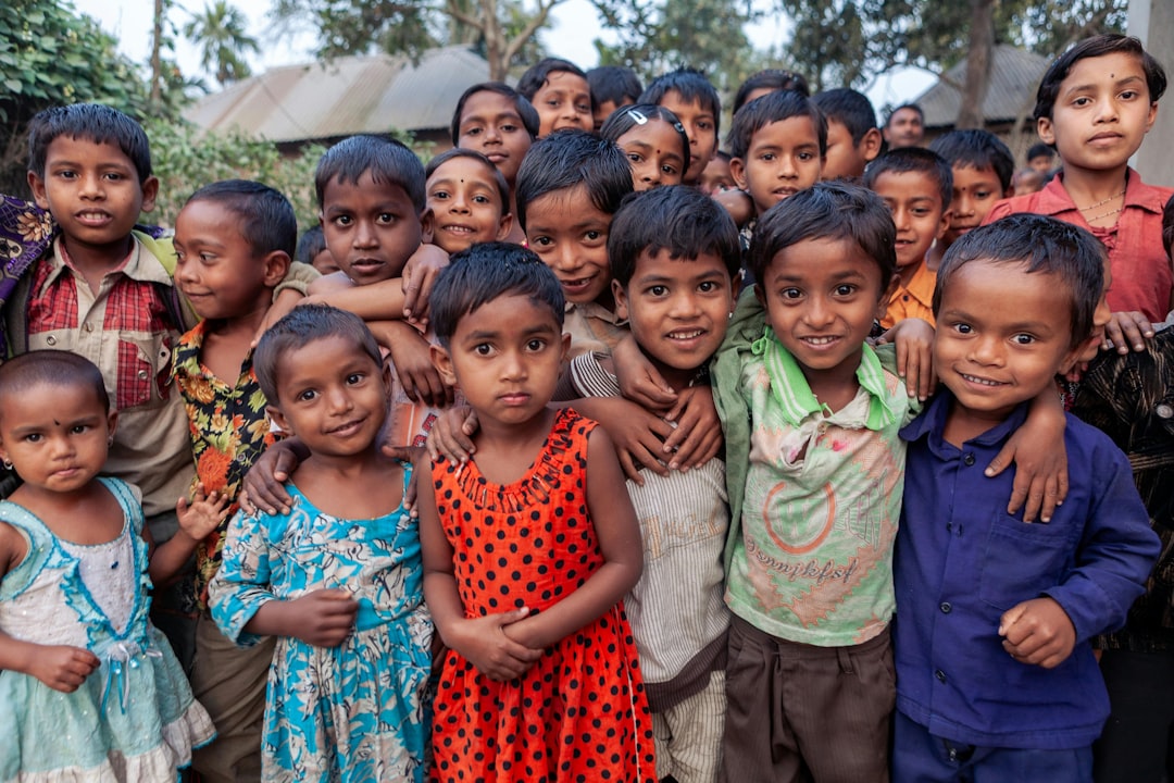 group-of-smiling-children-standing-closely-together-outdoors-pmxc4wv97d0